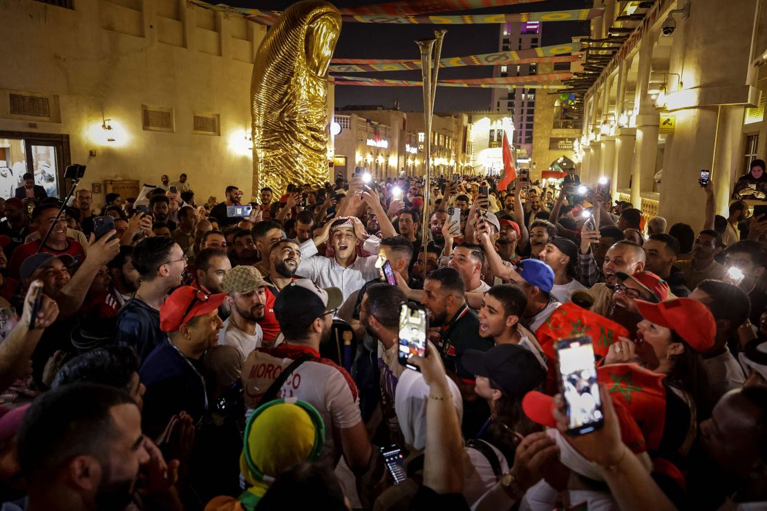 Supporters dance and sing at the Souq Waqif in Doha on November 30, 2022, during the Qatar 2022 World Cup football tournament.