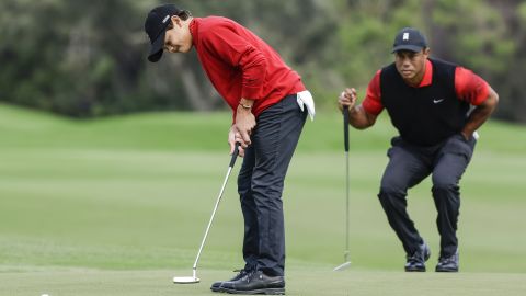 Charlie Woods bets while Father Tiger watches.