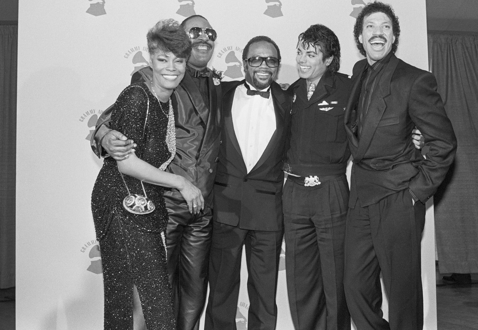 Warwick, Wonder, Quincy Jones, Michael Jackson and Lionel Richie celebrate backstage at the Grammy Awards in February 1986.