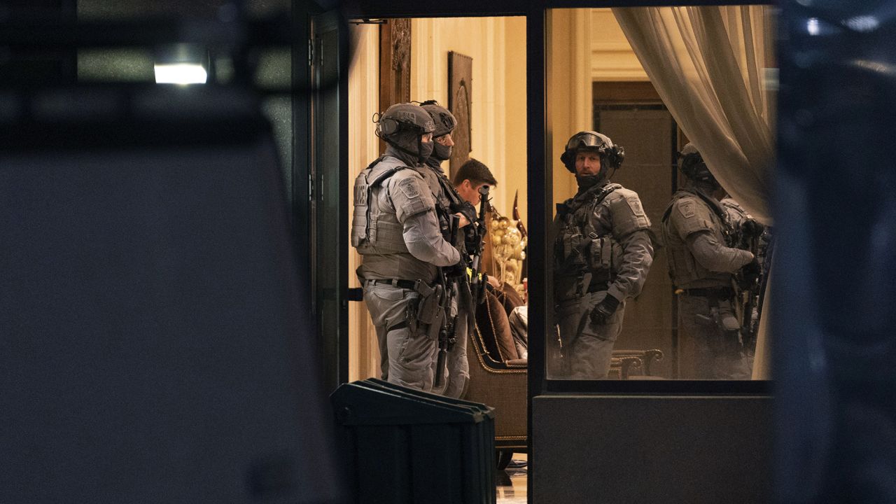 York Regional Police tactical officers stand in the lobby of a condominium in Vaughan, Ontario, on Sunday. Five people and a suspect are dead after a shooting in the building, police said.