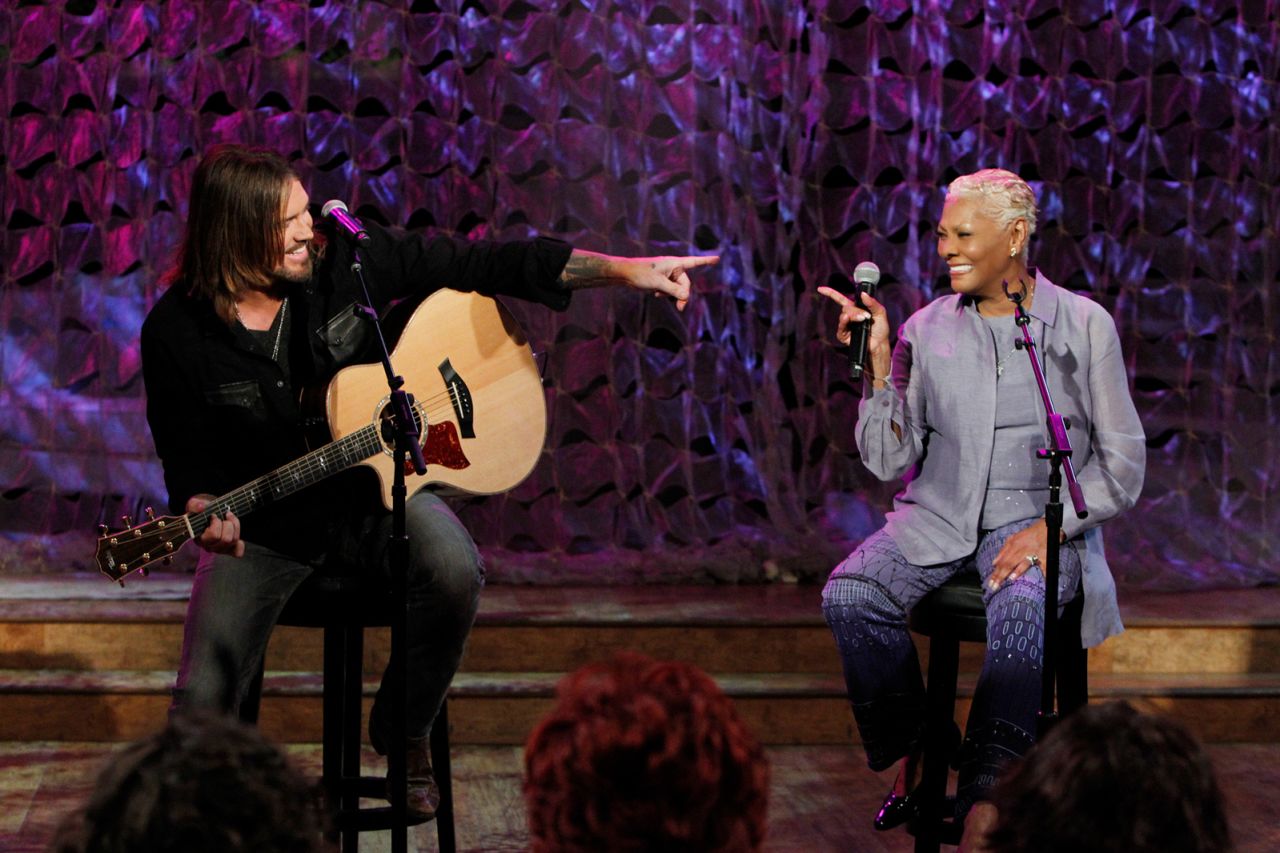 Billy Ray Cyrus and Warwick perform a duet on "The Talk" in 2014. The pair collaborated on the song "Love Is Just Ahead."