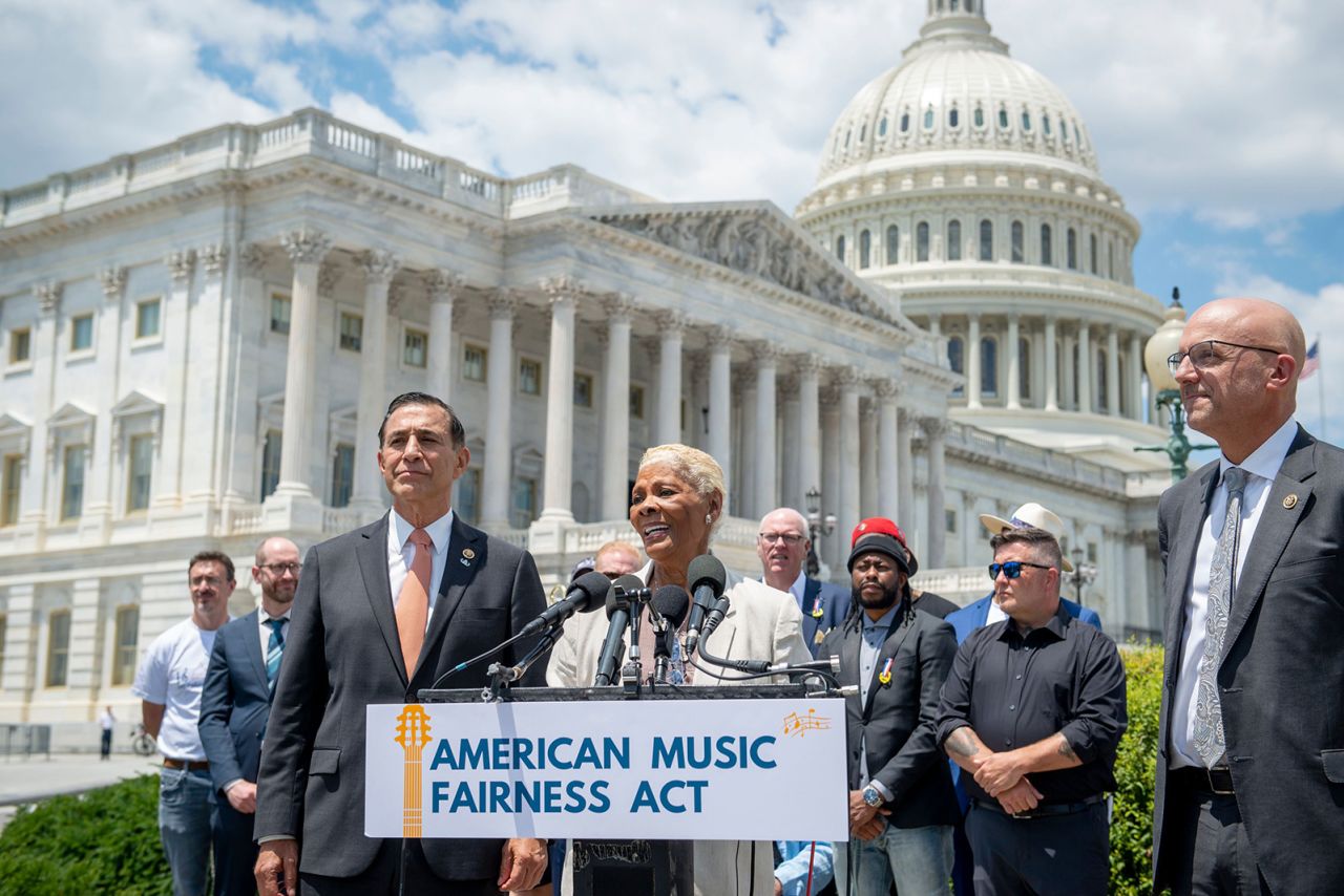 US Rep. Darrell Issa, left, listens as Warwick introduces the American Music Fairness Act in Washington, DC, in June 2021. Warwick has been an outspoken supporter of musical artists and has lobbied Congress to pass laws that would ensure they receive fair compensation. 