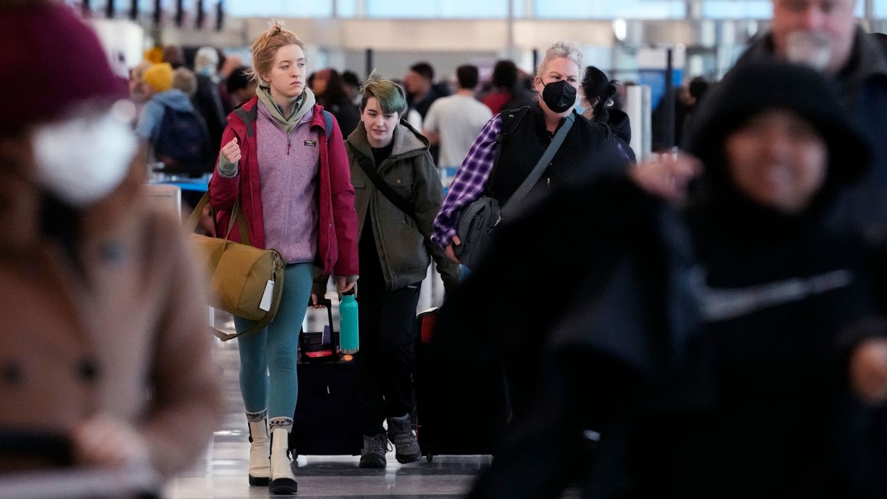 Travelers walk through Terminal 3 at O'Hare International Airport in Chicago on Monday