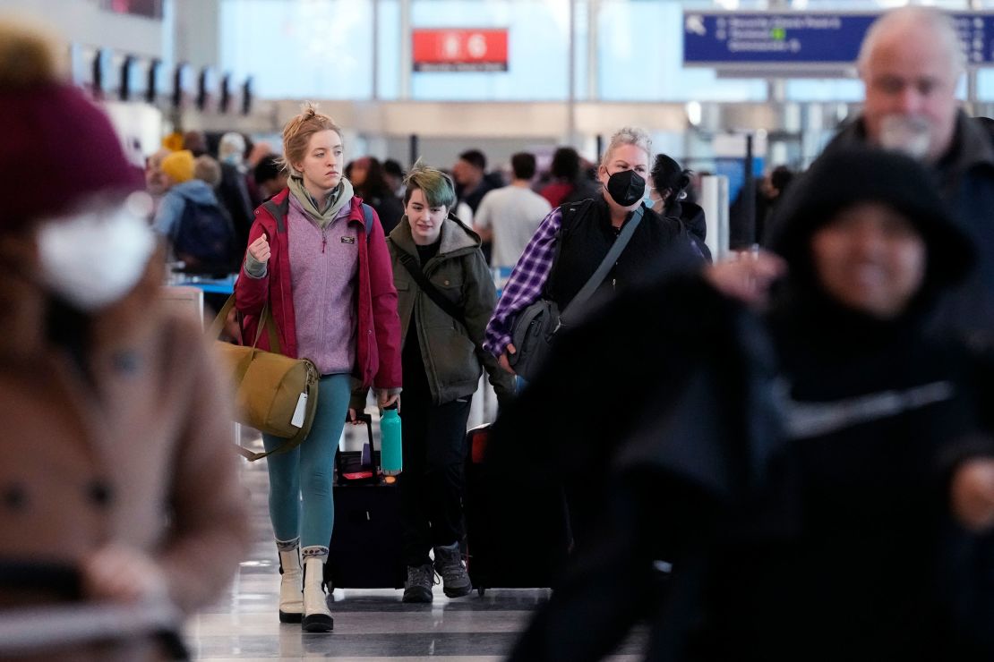 Travelers walk through Terminal 3 at O'Hare International Airport in Chicago on Monday