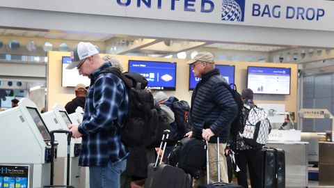 Passengers check in for United Airlines flights at O'Hare International Airport in Chicago on December 13.