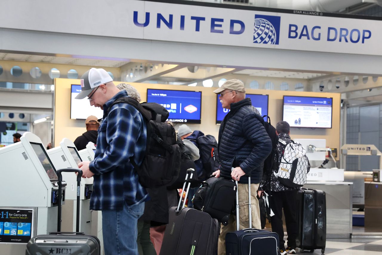 Passengers check in for United Airlines flights at O'Hare International Airport in Chicago on December 13.