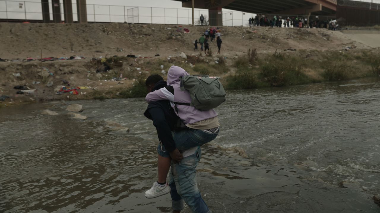 A group of migrants cross the Rio Grande into the US in Ciudad Juarez at to the Mexico-US border on December 18, 2022.
