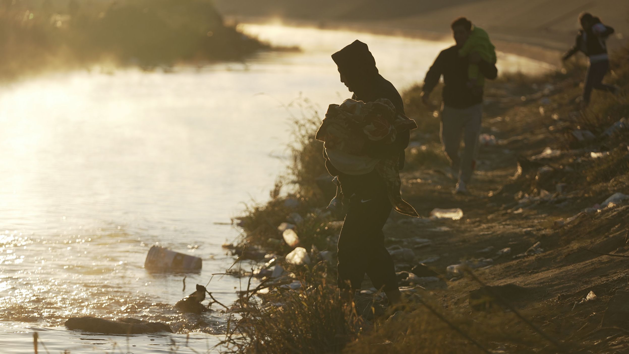 A group of migrants in Ciudad Juarez cross the Rio Grande into the US at the Mexico-US border on December 19, 2022.