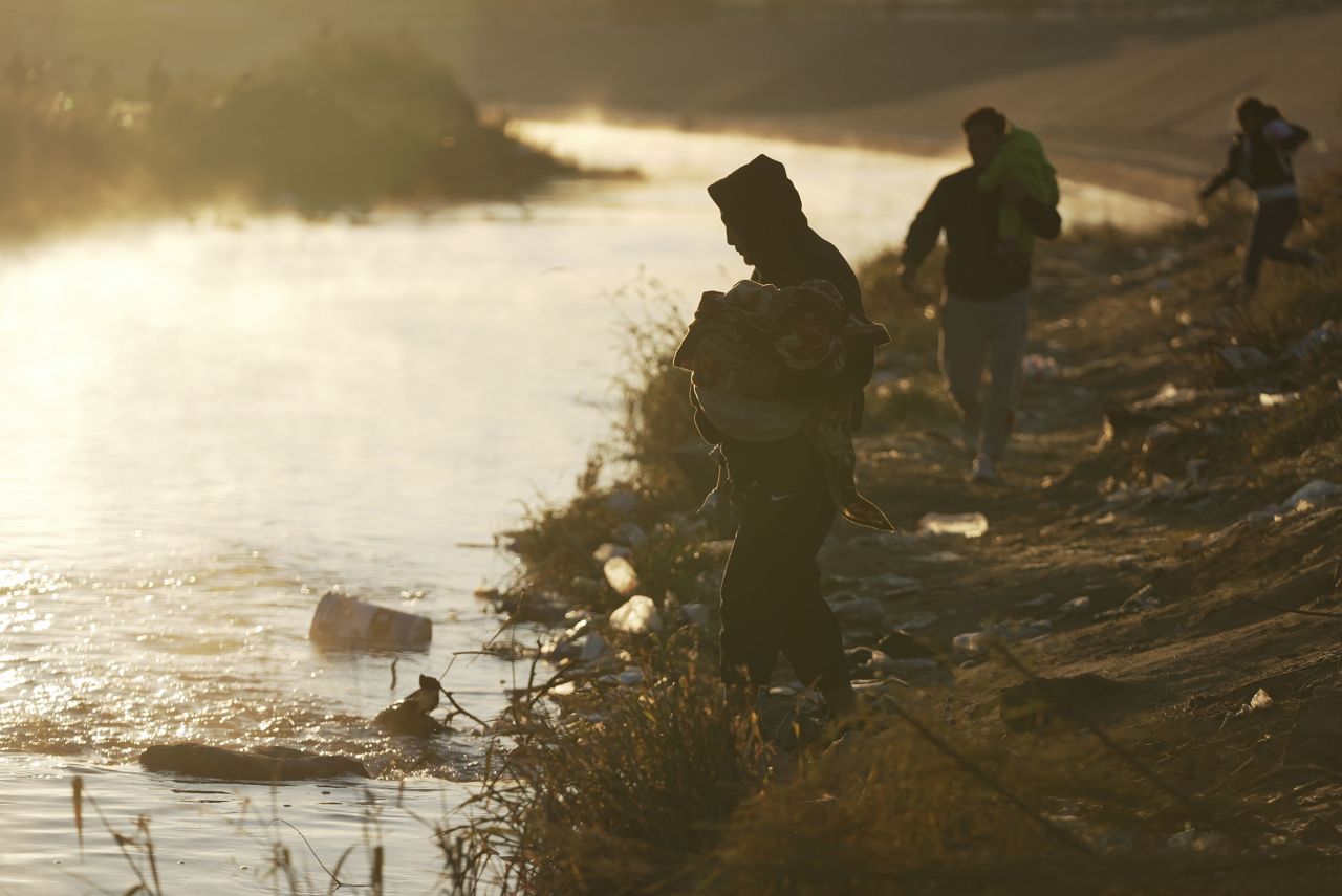 A group of migrants cross the Rio Grande into the United States on December 19.