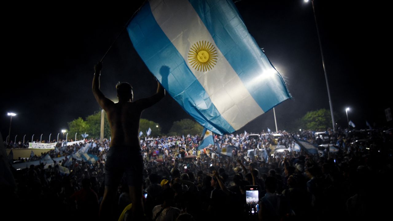 Fans gather outside the Argentine Football Association's training ground ahead of the team's arrival.