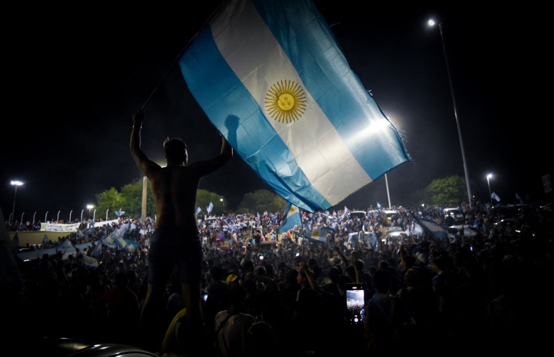 Fans gather outside the Argentine Football Association's training ground ahead of the team's arrival.