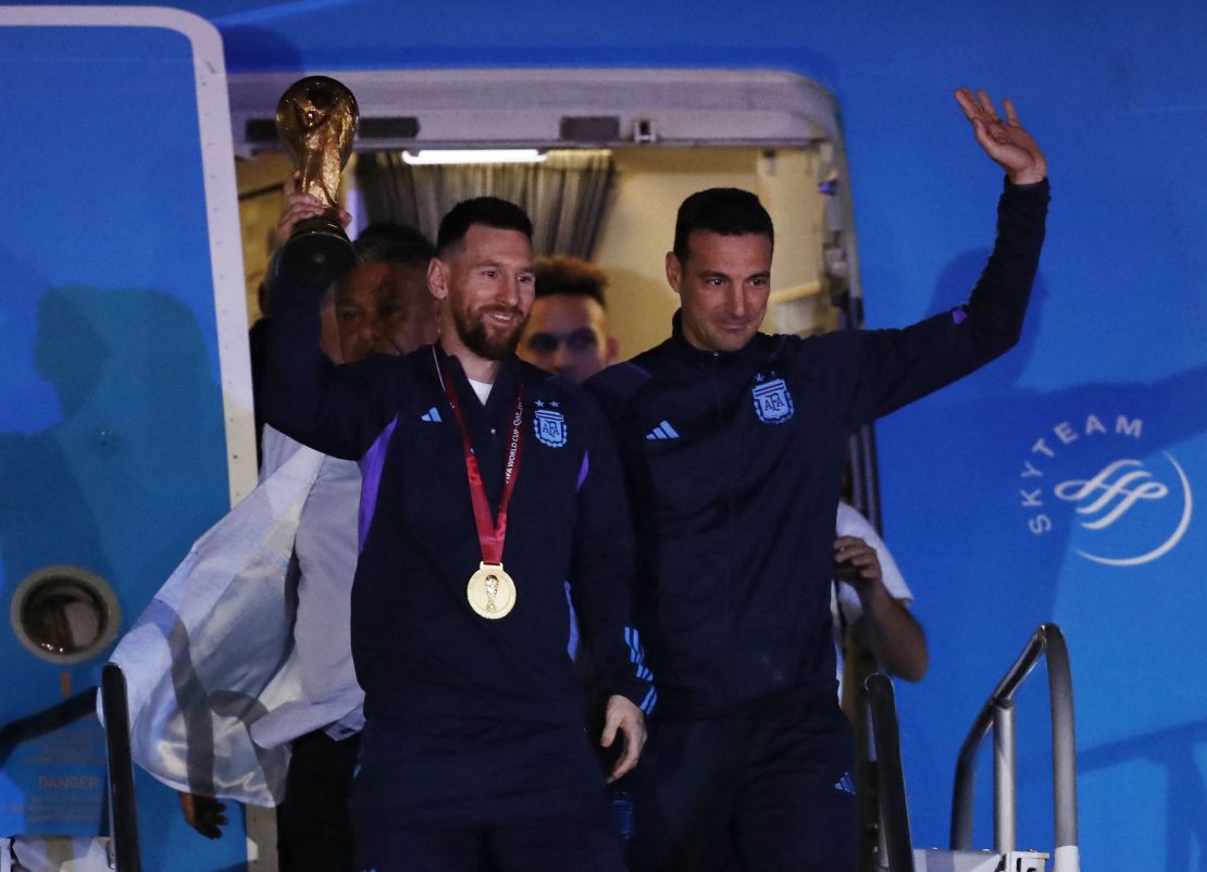 Lionel Messi leads the Argentina team as they step off the plane in Buenos Aires on December 20.