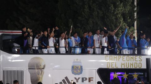 Argentine players waving from the top of the bus after arriving in Buenos Aires.