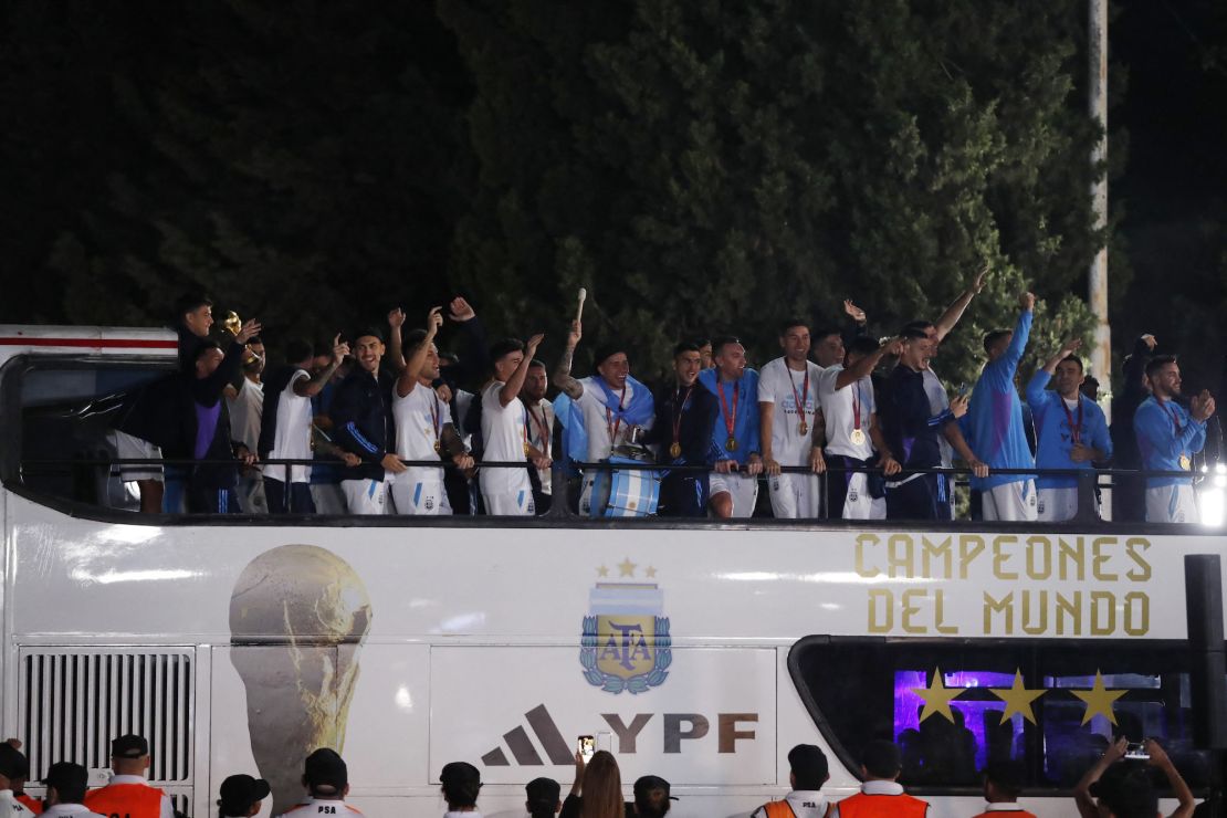 Argentina players wave from the top of a bus after their arrival in Buenos Aires.