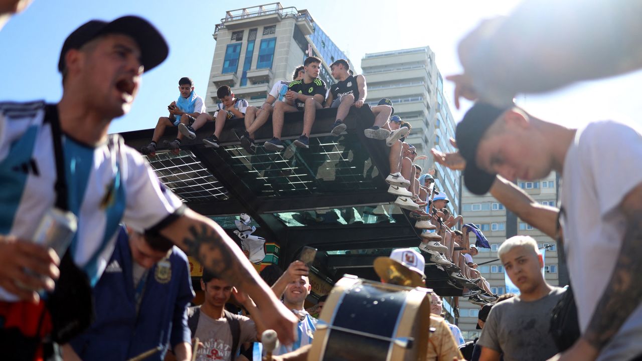 Fans climbed up high to try and get a view of the Argentina bus.