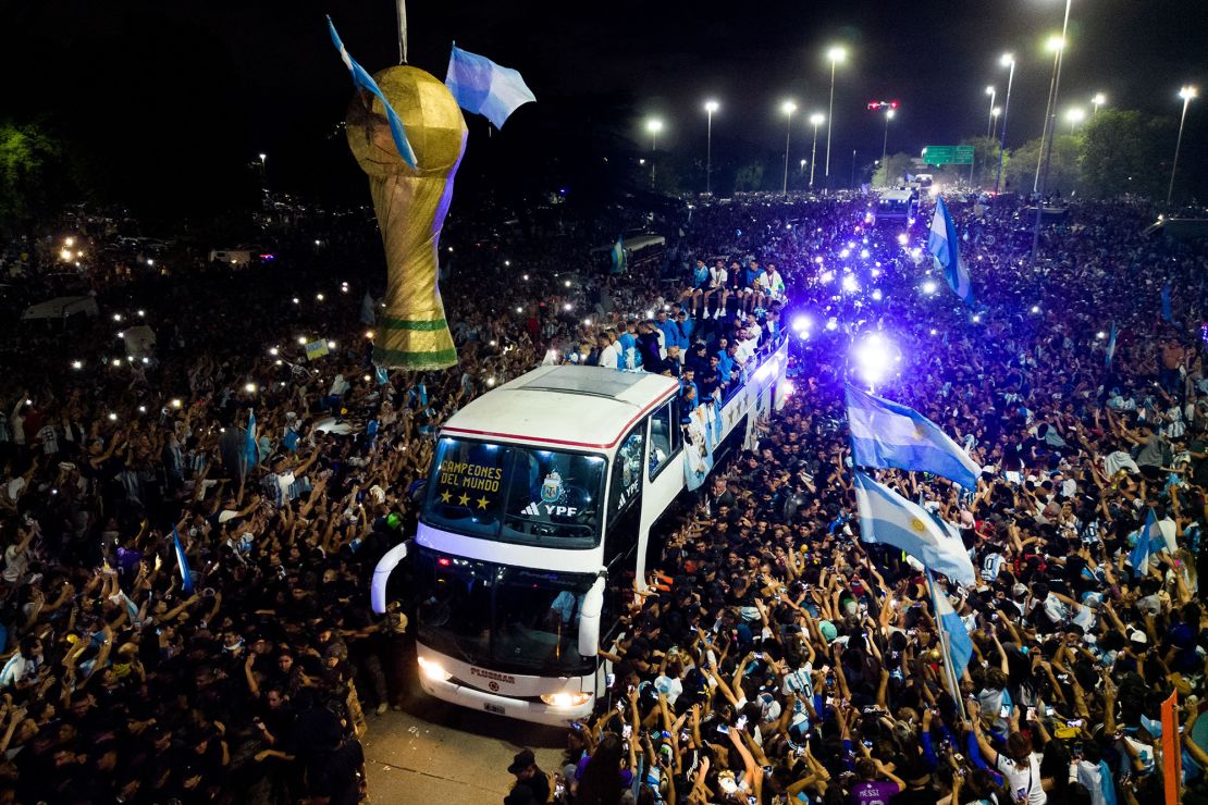Argentina's players celebrate on board a bus with supporters after winning the World Cup.