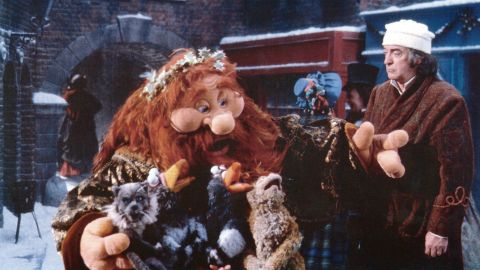 The Ghost of Christmas Present, left, and Michael Caine, right, in 1992's