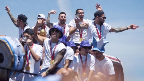 I giocatori dell'Argentina festeggiano sull'autobus con il trofeo della Coppa del Mondo durante la parata di martedì. 