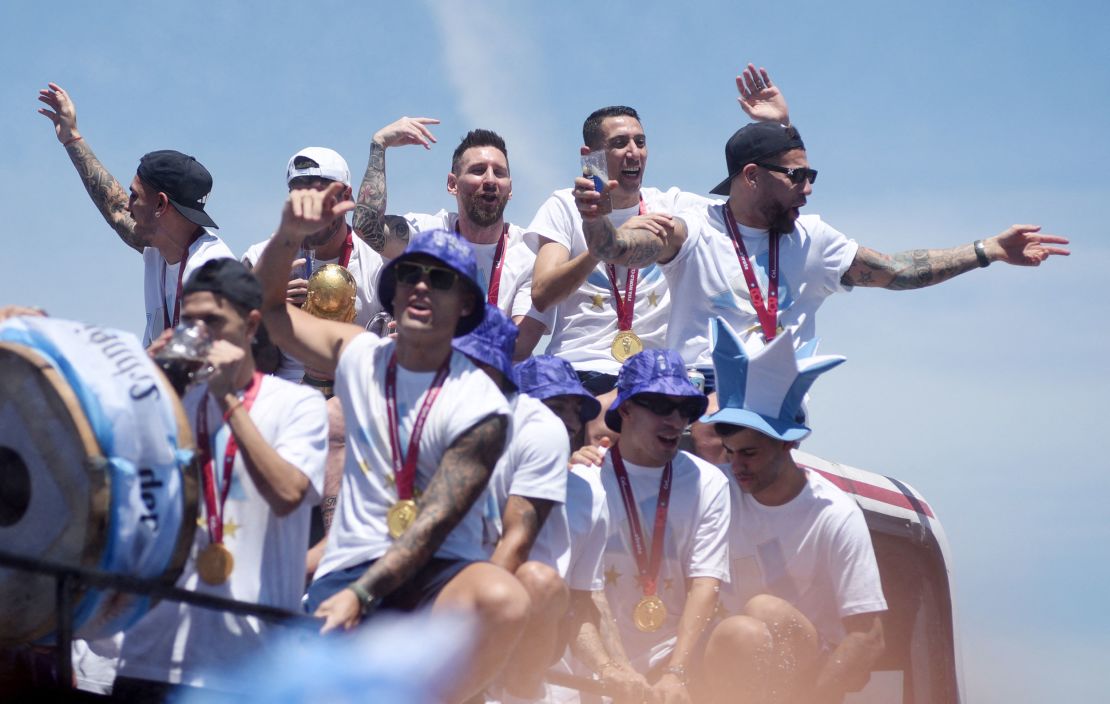 Argentina players celebrate on the bus with the World Cup trophy during Tuesday's parade. 