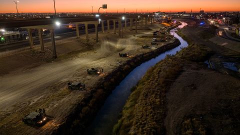 Texas National Guard troops and state troopers line the bank of the Rio Grande on December 20, 2022 as viewed from Ciudad Juarez, Mexico. 