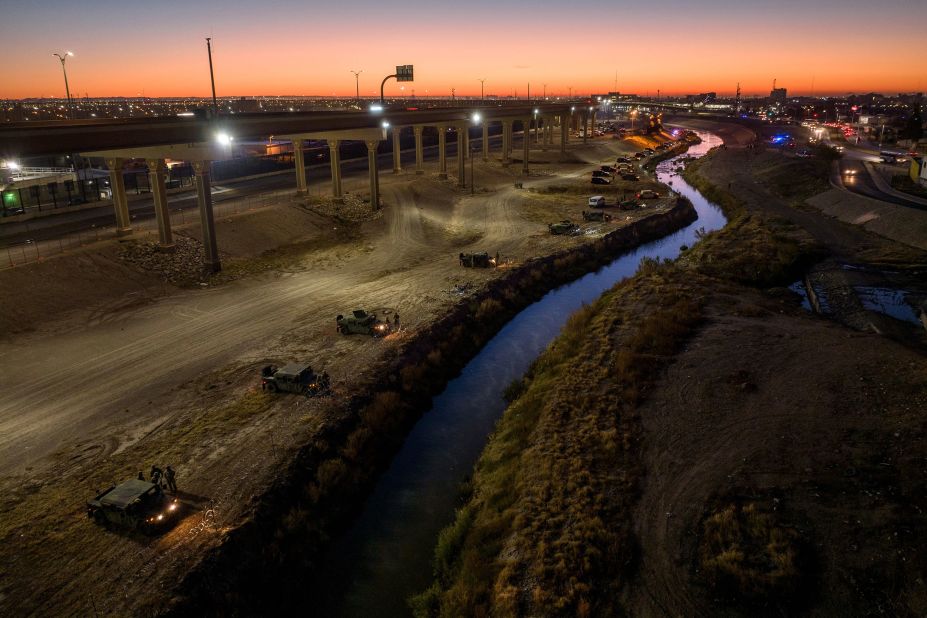 The Texas National Guard and state troopers line the bank of the Rio Grande on December 20.