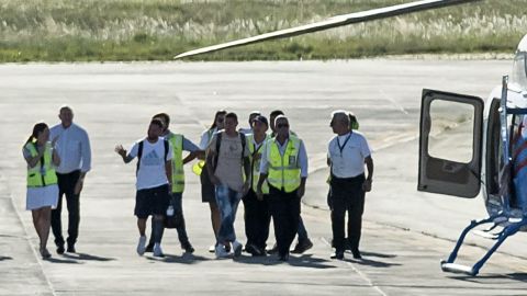 Messi and Di Maria prepare to board a helicopter at Islas Malvinas International Airport before heading to their home in Rosario, Santa Fe province, Argentina.