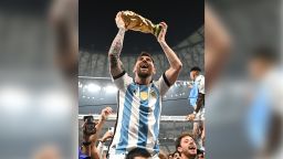 LUSAIL CITY, QATAR - DECEMBER 18:  Lionel Messi of Argentina celebrates with the World Cup Trophy after winning the FIFA World Cup Qatar 2022 Final match between Argentina and France at Lusail Stadium on December 18, 2022 in Lusail City, Qatar. (Photo by Shaun Botterill - FIFA/FIFA via Getty Images)