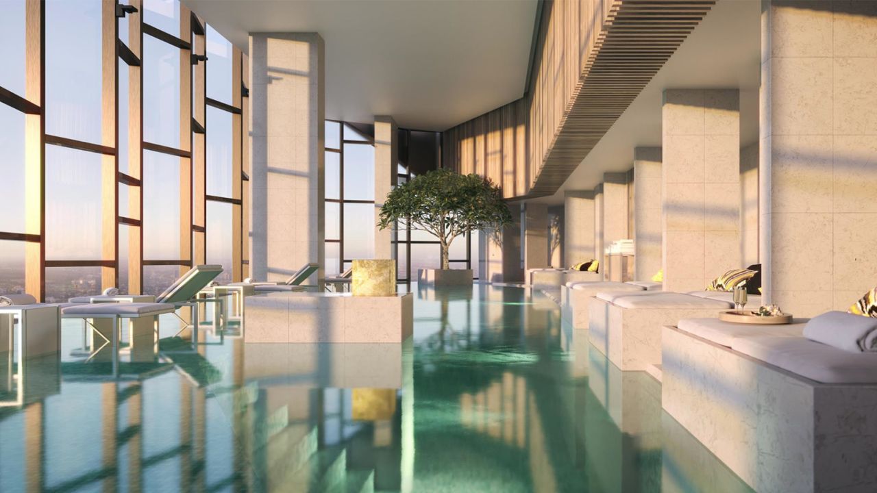A heated infinity pool framed by floor-to-ceiling glass windows overlooks the city at The Ritz-Carlton Melbourne.