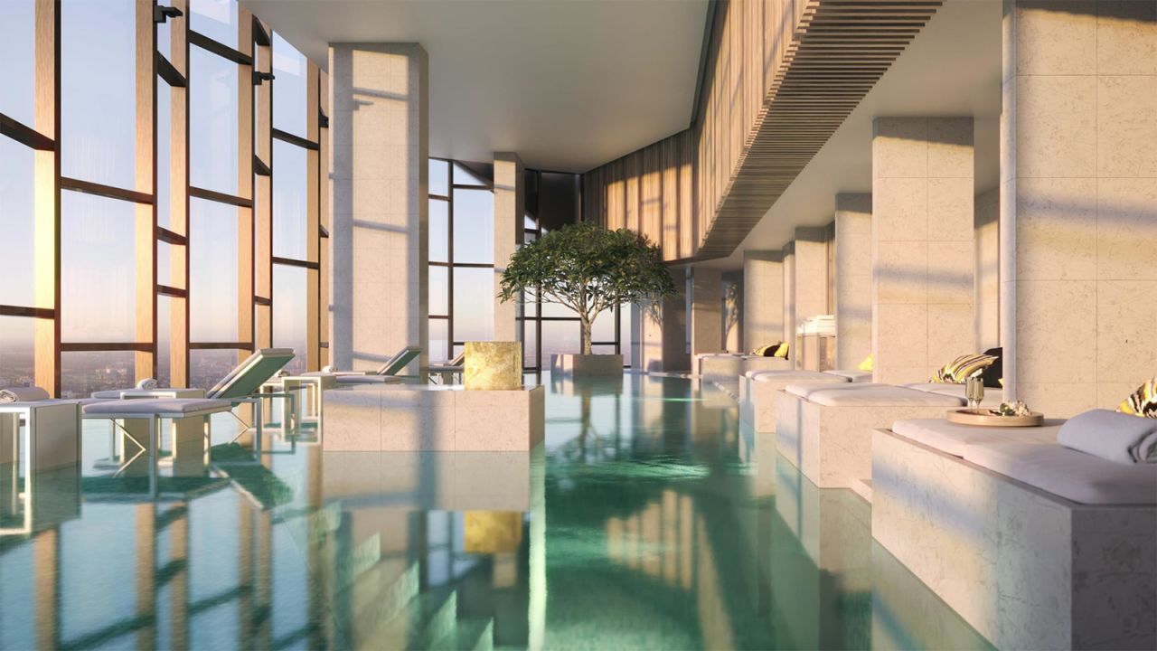 A heated infinity pool framed by floor-to-ceiling glass windows overlooks the city at The Ritz-Carlton Melbourne.