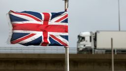 A truck passes a British Union flag, also known as a Union Jack, at the Port of Dover Ltd. in Dover, U.K., on Thursday, April 1, 2021. The U.K. government has delayed, until Oct. 1, imposing post-Brexit checks on food imports coming from the European Union. 