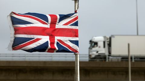 A truck passes a Union Jack, at the Port of Dover on April 1, 2021. The UK government has delayed post-Brexit checks on EU food imports until the end of 2023. 