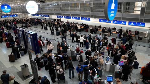 Travelers check in for their flights at Terminal 1 at Minneapolis-St. Paul International Airport in Minnesota on Wednesday.