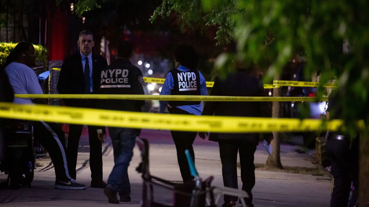 NYPD officers investigate the scene of a shooting in Brooklyn on Thursday, July 21, 2022.