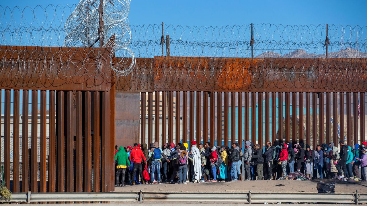 Migrants wait in line to be let in by the Border Patrol into El Paso, Texas from Ciudad Juarez, Mexico, Wednesday, Dec. 21, 2022. Thousands of migrants gathered along the Mexican side of the southern border Wednesday, camping outside or packing into shelters as they waited for the U.S. Supreme Court to decide whether and when to lift pandemic-era restrictions that have prevented many from seeking asylum. (AP Photo/Andres Leighton)