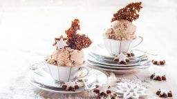Tea cups of cinnamon star ice cream with caramelized nuts can make a sweet Christmas dessert.