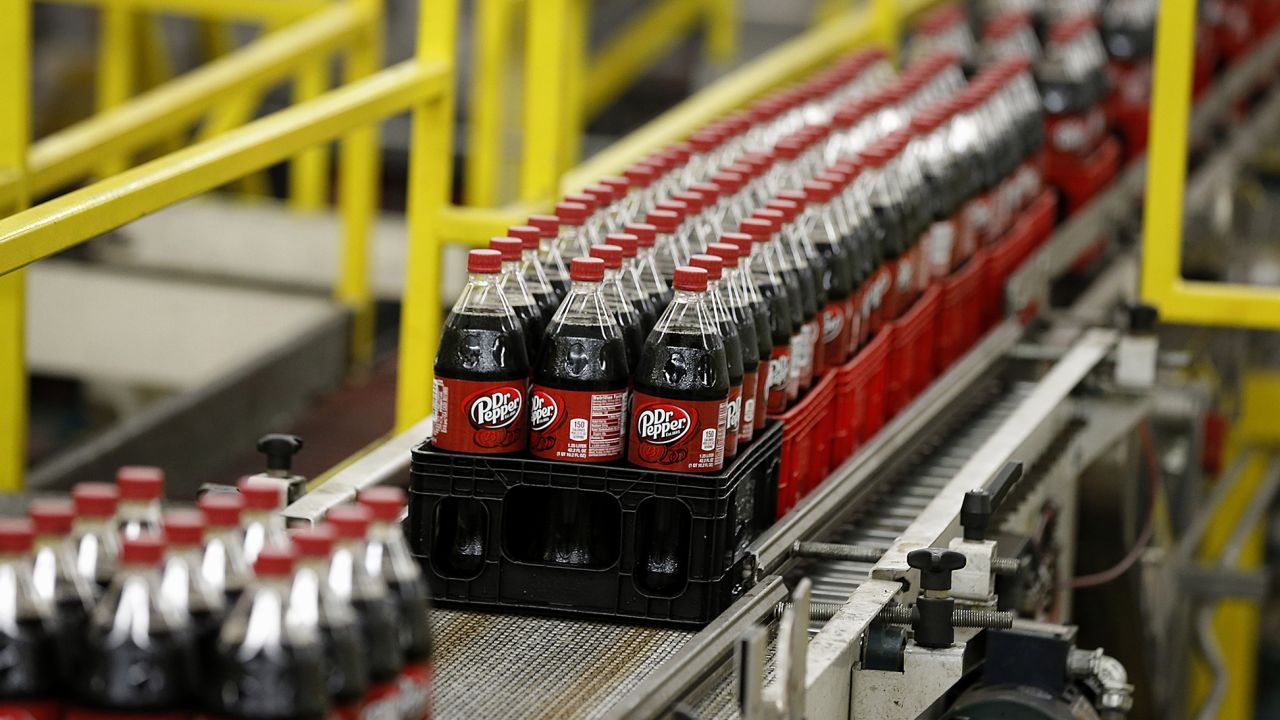 Bottles of Dr. Pepper move down a production line at the Swire Coca-Cola bottling plant in Utah.