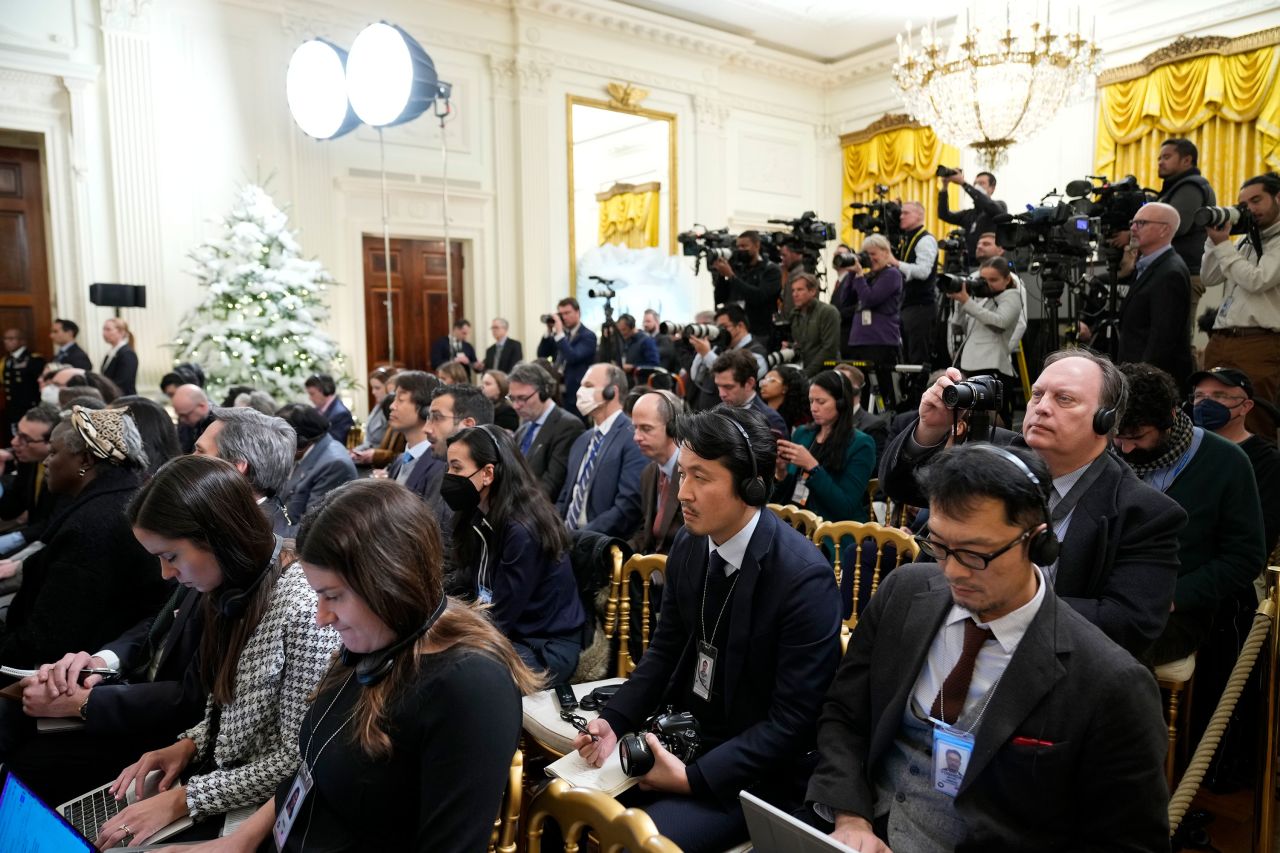 Members of the media listen during the news conference in the East Room of the White House.