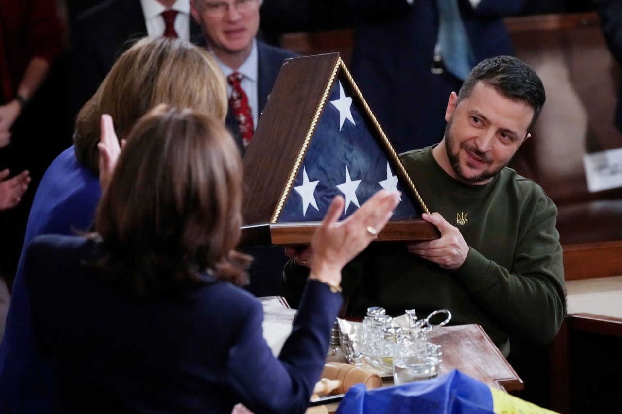 Zelensky holds an American flag that was gifted to him by Pelosi. The flag was flown over the Capitol earlier in the day.