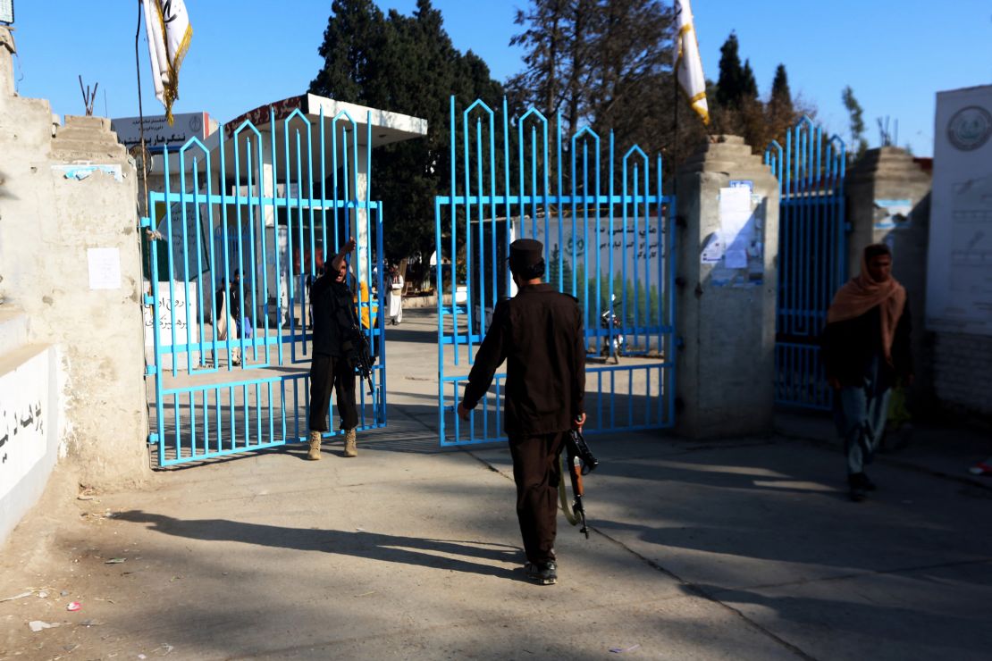 Taliban security personnel stand guard at the entrance gate of a university in Jalalabad on December 21, 2022. 