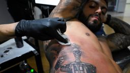 Cristian Grillo, 34, gets a tattoo of Argentina's soccer star Lionel Messi's shirt under the FIFA World Cup trophy, after Argentina's soccer national team won FIFA World Cup Qatar 2022, in Buenos Aires, Argentina, December 20, 2022. REUTERS/Magali Druscovich