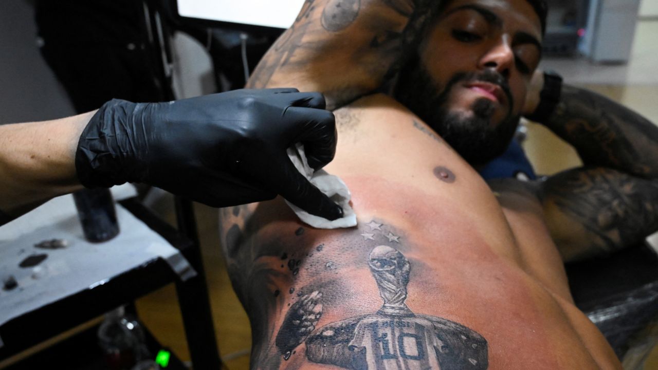 Cristian Grillo, 34, gets a tattoo of Argentina's soccer star Lionel Messi's shirt under the World Cup trophy.