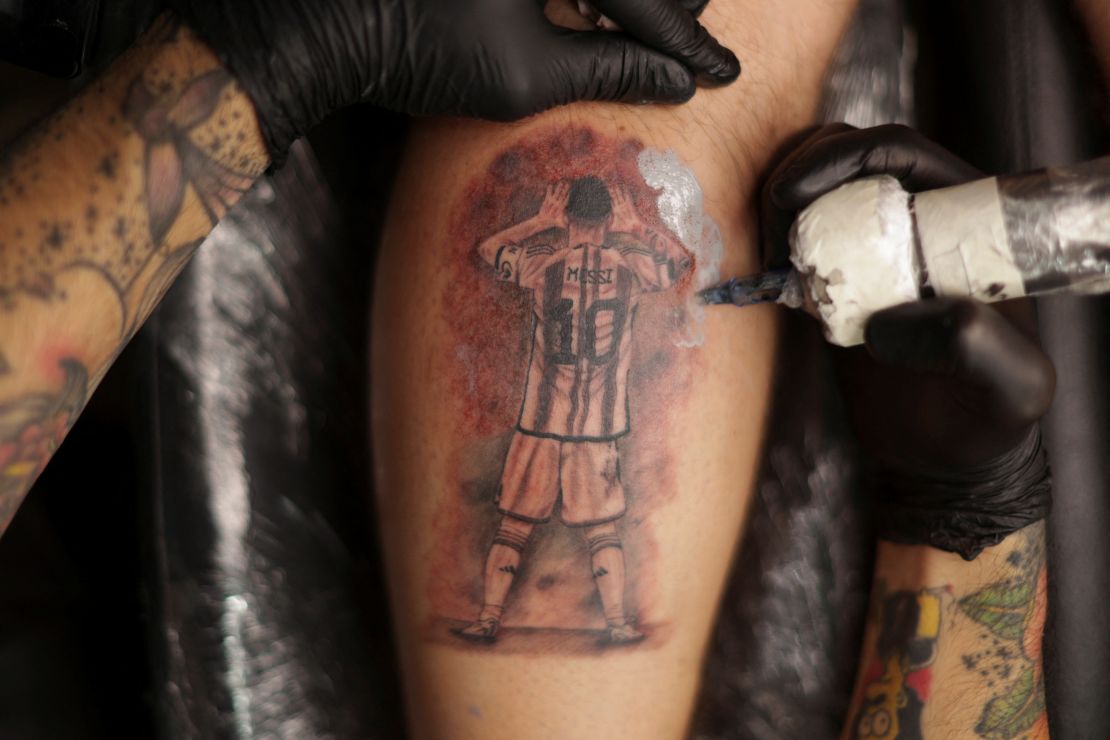 Fermin Robilotte, 27, gets a tattoo of Argentina's World Cup winning captain.