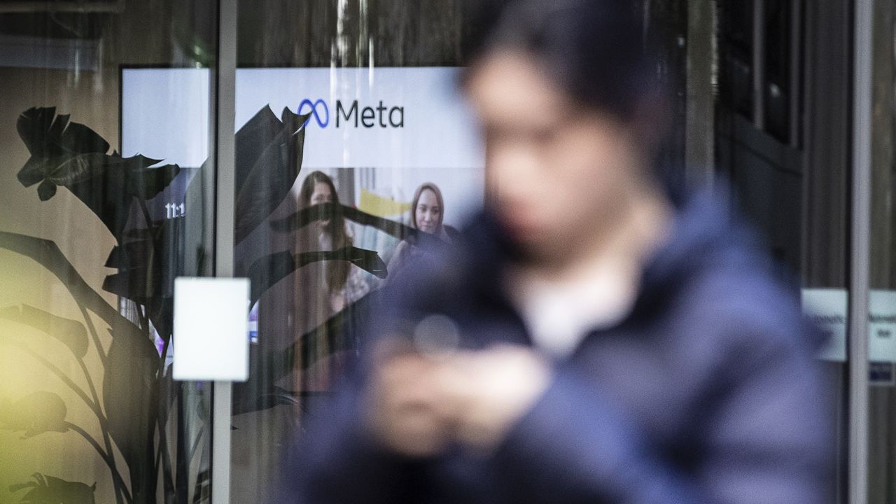A person walking past the offices of Meta, the parent company of Facebook and Instagram, in King's Cross, London, on November 9. Meta has confirmed it plans to cut more than 11,000 jobs globally as part of a major restructuring of the tech giant. The cuts will reduce the size of the company's workforce by about 13 percent. 