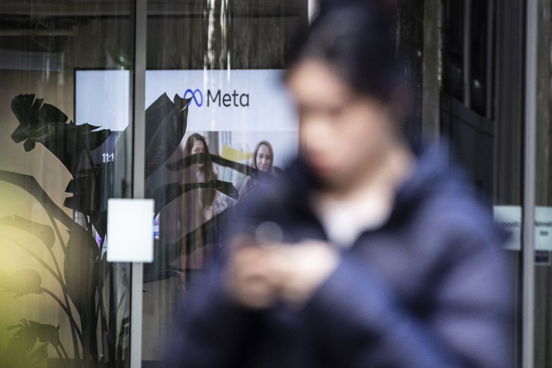 A person walking past the offices of Meta, the parent company of Facebook and Instagram, in King's Cross, London, on November 9. Meta has confirmed it plans to cut more than 11,000 jobs globally as part of a major restructuring of the tech giant. The cuts will reduce the size of the company's workforce by about 13 percent. 