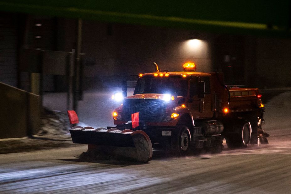 An Iowa Department of Transportation plow clears a road in Iowa City on December 21.