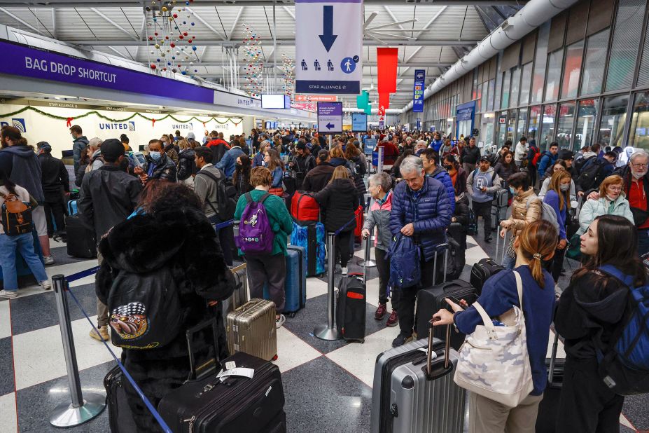 Travelers arrive for their flights at O'Hare International Airport on December 22 in Chicago. 