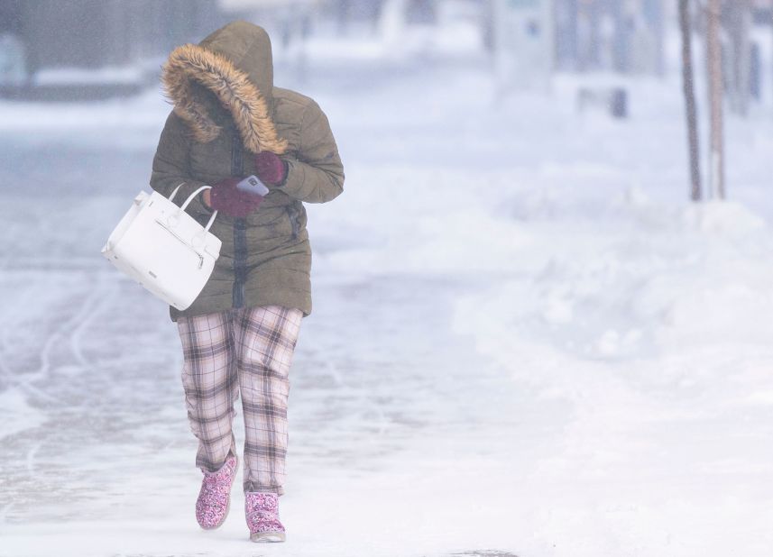 A person walks through the snow on December 22 in downtown Minneapolis. 