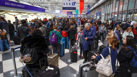 Travelers arrive for their flights at Chicago's O'Hare International Airport on December 22, 2022.