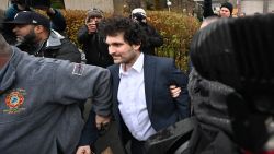 FTX founder Sam Bankman-Fried leaves following his arraignment in New York City on December 22, 2022. - New York judge Gabriel Gorenstein ordered Bankman-Fried be released on $250 million bail Thursday while he awaits trial on criminal fraud charges over the spectacular collapse of his crypto exchange.