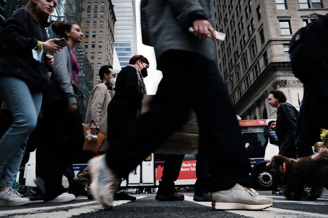 Young professionals navigate Manhattan streets on March 31, 2022, in New York City. 
